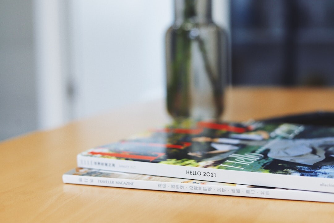 Stack of glossy magazines and newspapers on a table