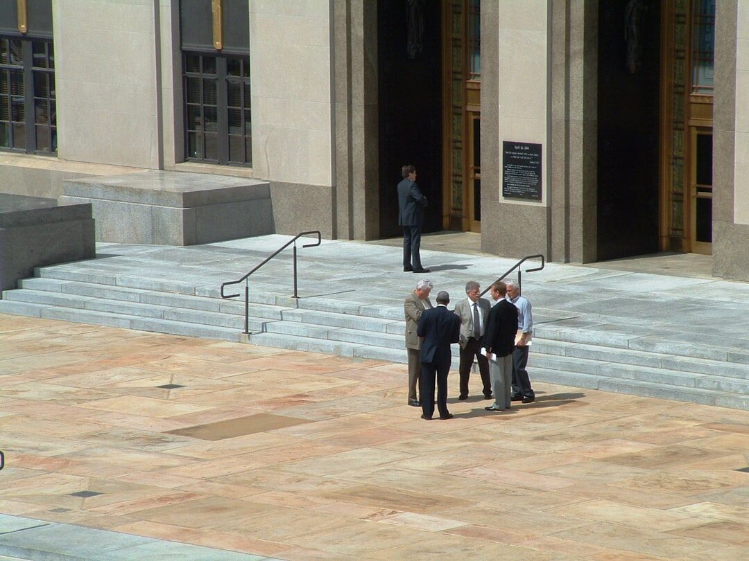 Celebrity leaving a courthouse surrounded by photographers
